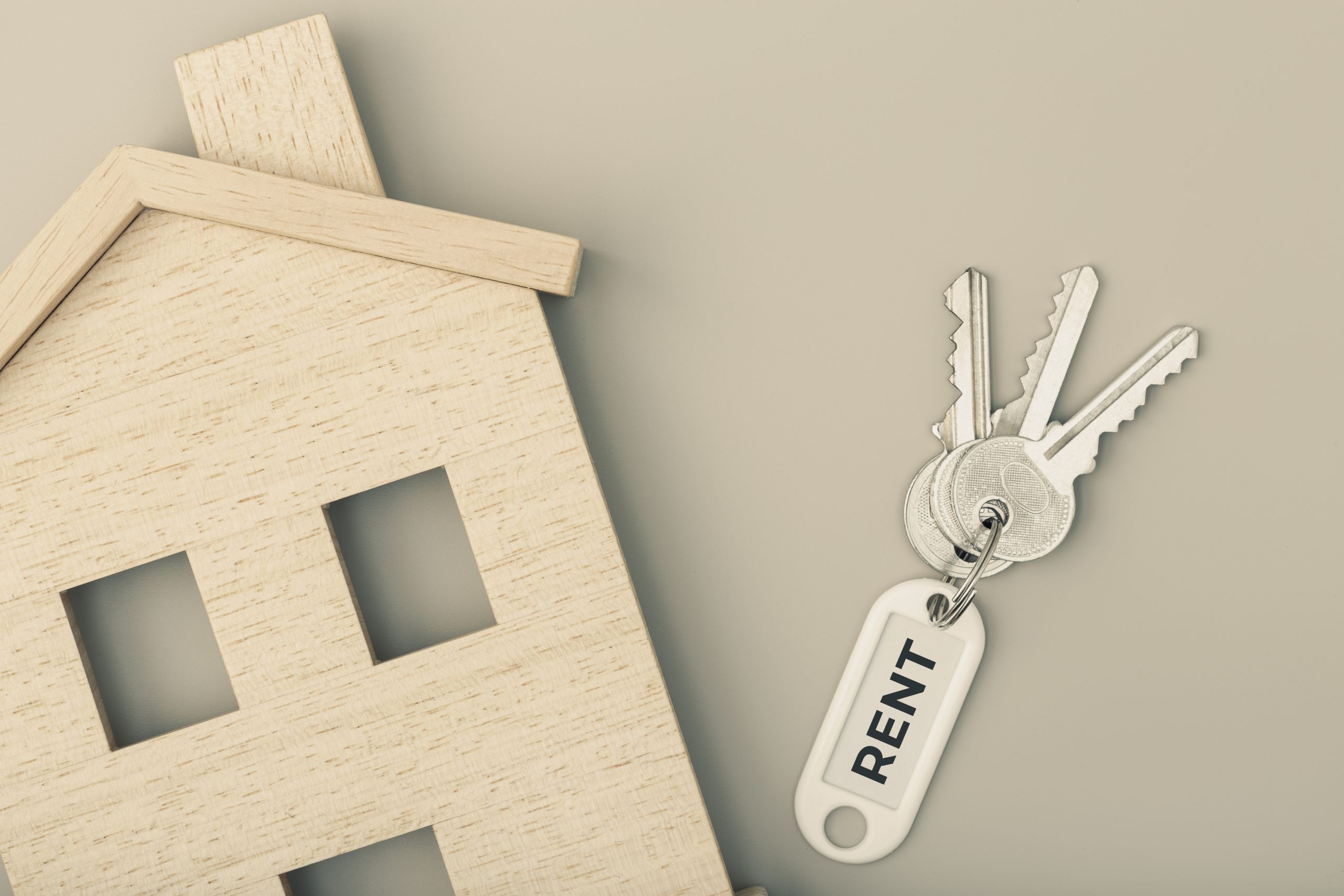 Rent a house concept. Real estate market. House icon with keys. Copy space. Top view